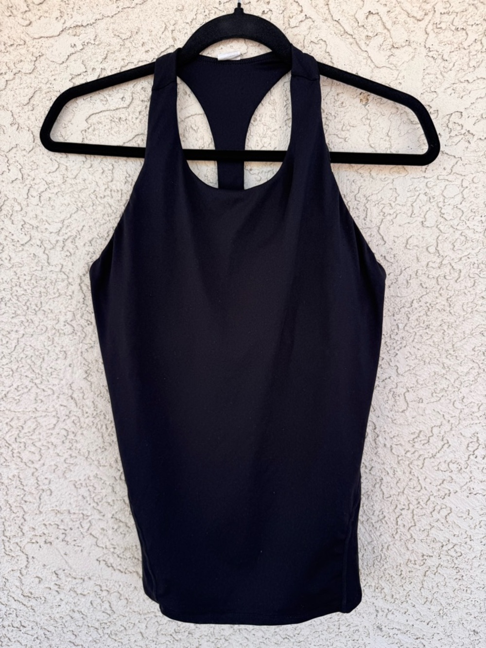 Fabletics black racerback tank top with silver criss-cross strap details